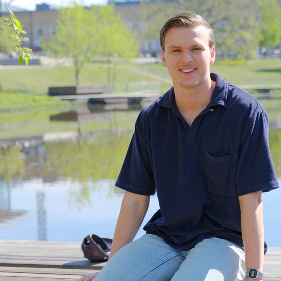 Carl Göransson sittandes framför campusdammen.