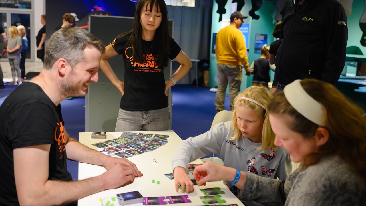 A group of people standing around a table.