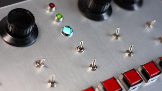 A close up of a control panel with buttons and knobs.