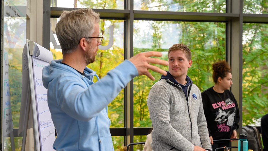 Two people speak to each other 