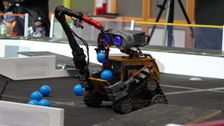 robot picking up blue balls