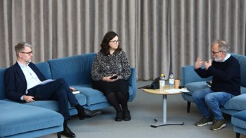 En grupp människor som sitter i soffor i ett rum.