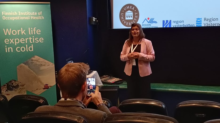 Rebecca Tapper on stage, presenting her research