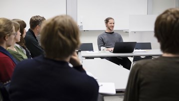 six people sitting around a conference table.